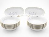 six white and gold plates with floral designs are stacked on top of each other