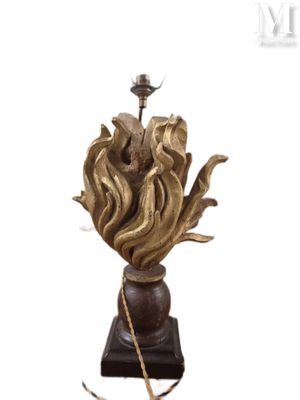 a statue of a flower on a pedestal with a rope