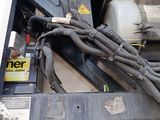 a close up of a truck engine with wires attached to it