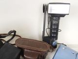 a camera, a camera case, and a bag on a table