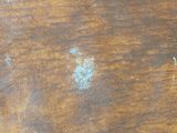 a close up of a wooden table with some paint on it