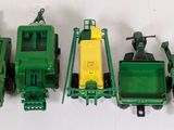four green toy trains sitting next to each other on a white surface