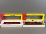 two red and yellow train cars sitting next to each other on a table