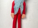 a stuffed toy of a person with a scarf around his neck