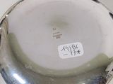 a silver plate with a sticker on it sitting on a table