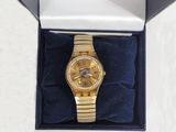 an image of a gold watch in a box on a white surface