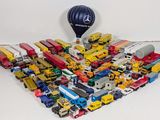 a lot of toy vehicles and a hot air balloon on the table