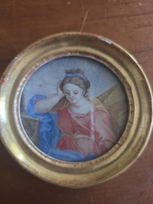 painting of a woman with a bird in her hand in a gold frame