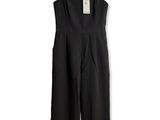 black jumpsuits on a hanger against a white background