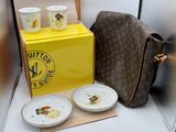 a louis vuitton bag and two plates on a table