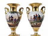 pair of antique vases with painted scenes on them sitting on a stand