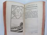 an open book with a picture of a town on it