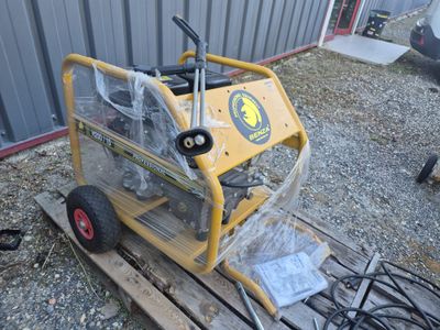 a small yellow machine that is sitting on a pallet