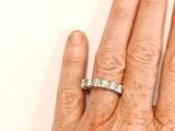 a woman ' s hand with a diamond ring on it