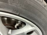 the tire of a car with a flat tire on it ' s rim