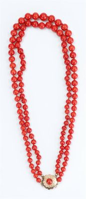 a red beaded necklace with a gold clasp on a white background
