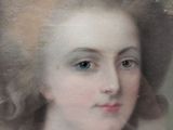 portrait of a woman with a pearl necklace and a tiable