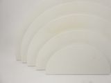 five white plates stacked on top of each other on a table