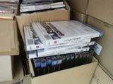 a lot of dvds stacked on top of each other in a box