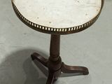 a small table with a marble top on a stand