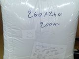 a white pillow sitting on top of a cardboard box on a table