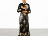 a statue of a man in a black robe holding a cross