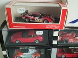 three red toy cars sitting on top of each other