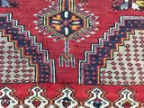 a close up of a red rug with a pattern on it