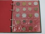 a red book with a bunch of coins inside of it