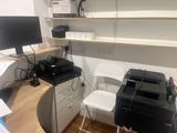 a desk with a printer and a printer on it