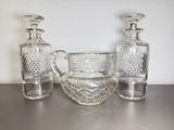 three glass vases sitting on a table next to each other