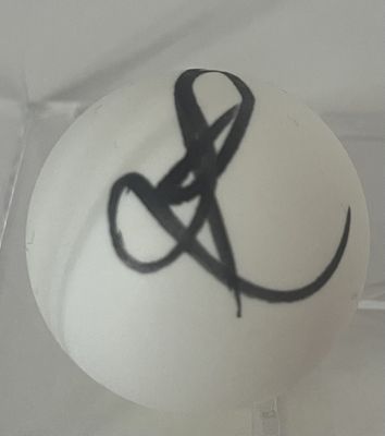 une boule blanche ornée d'un ruban noir