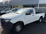 a picture of a white pick up truck parked in front of a building