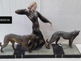 statue of a woman and two dogs on a marble base