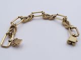 a close up of a gold bracelet on a white surface