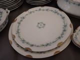 many plates and bowls sitting on a table together