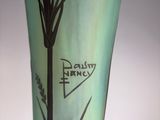 a green vase with a picture of a bird on it