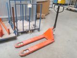 a fork lifter sitting in front of a pallet in a warehouse
