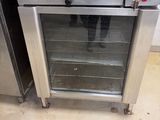 a stainless steel oven with a glass door in a kitchen