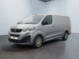 the silver van is parked in a white room with a black floor