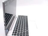 a white laptop with a black keyboard on a white surface