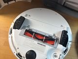 a white robot that is sitting next to a printer