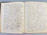 an open book with writing on it sitting on a table