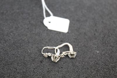 a small pair of earrings that are on a table