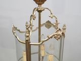 an antique brass and glass chandelier hanging from a ceiling