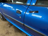 a blue car that is parked in a garage