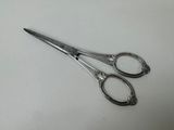 a pair of scissors sitting on a white surface