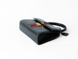 black leather handbag with red stripes and a gold clasp