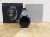 a close up of a watch sitting on a table next to a box