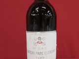 a bottle of red wine sitting on top of a red table